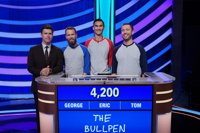 U of G alumni trivia team, called "The Bullpen" stand at podium with tv host, Colin Jost.