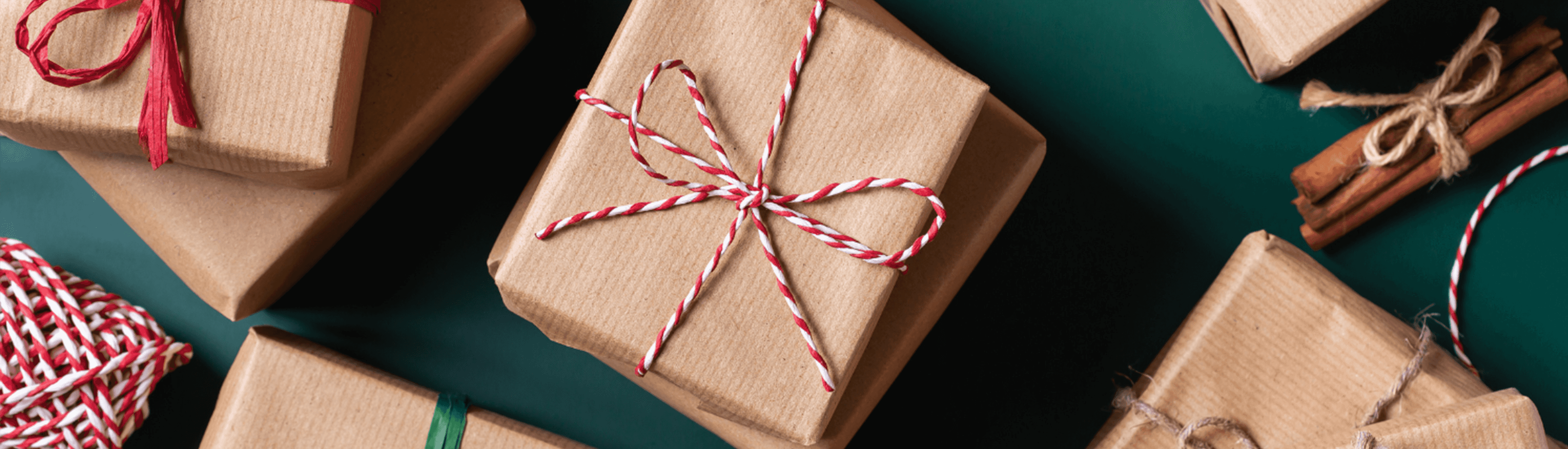 Wrapped holiday gifts tied with red and white string, featuring a festive and sustainable design.