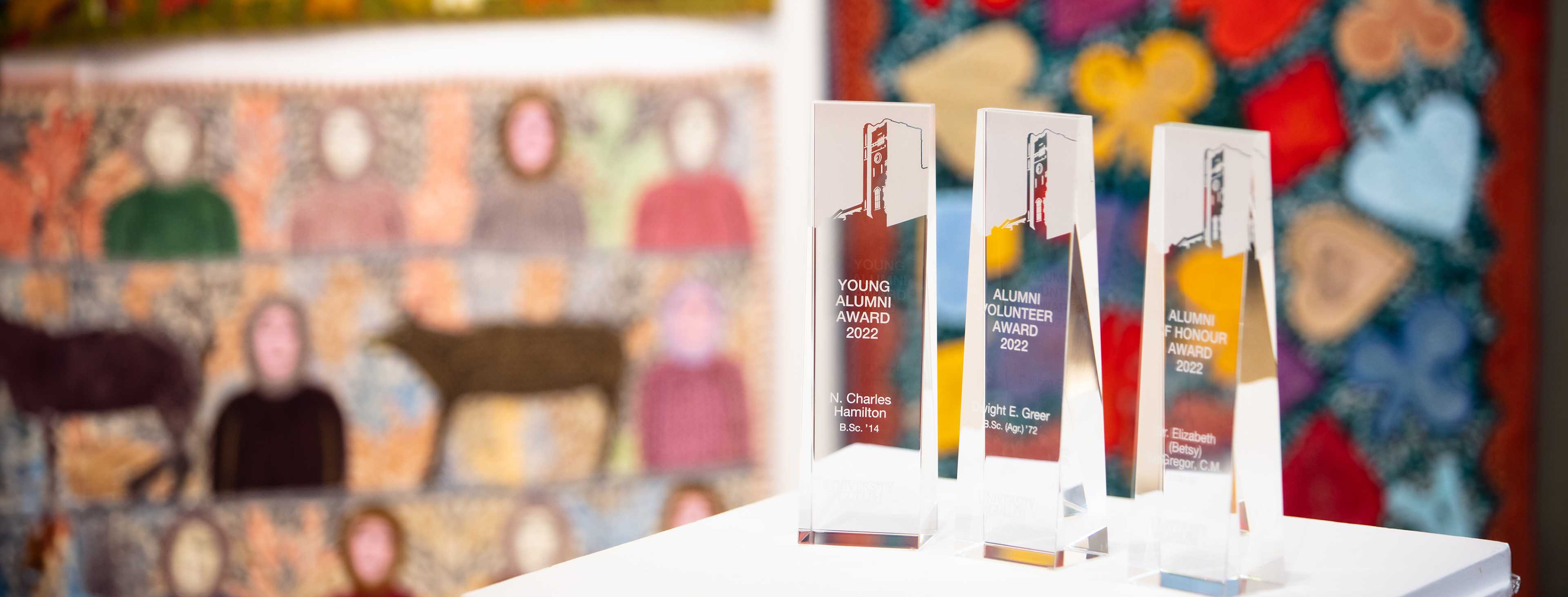 University of Guelph Awards of Excellence trophies 2022 with colorful artwork background